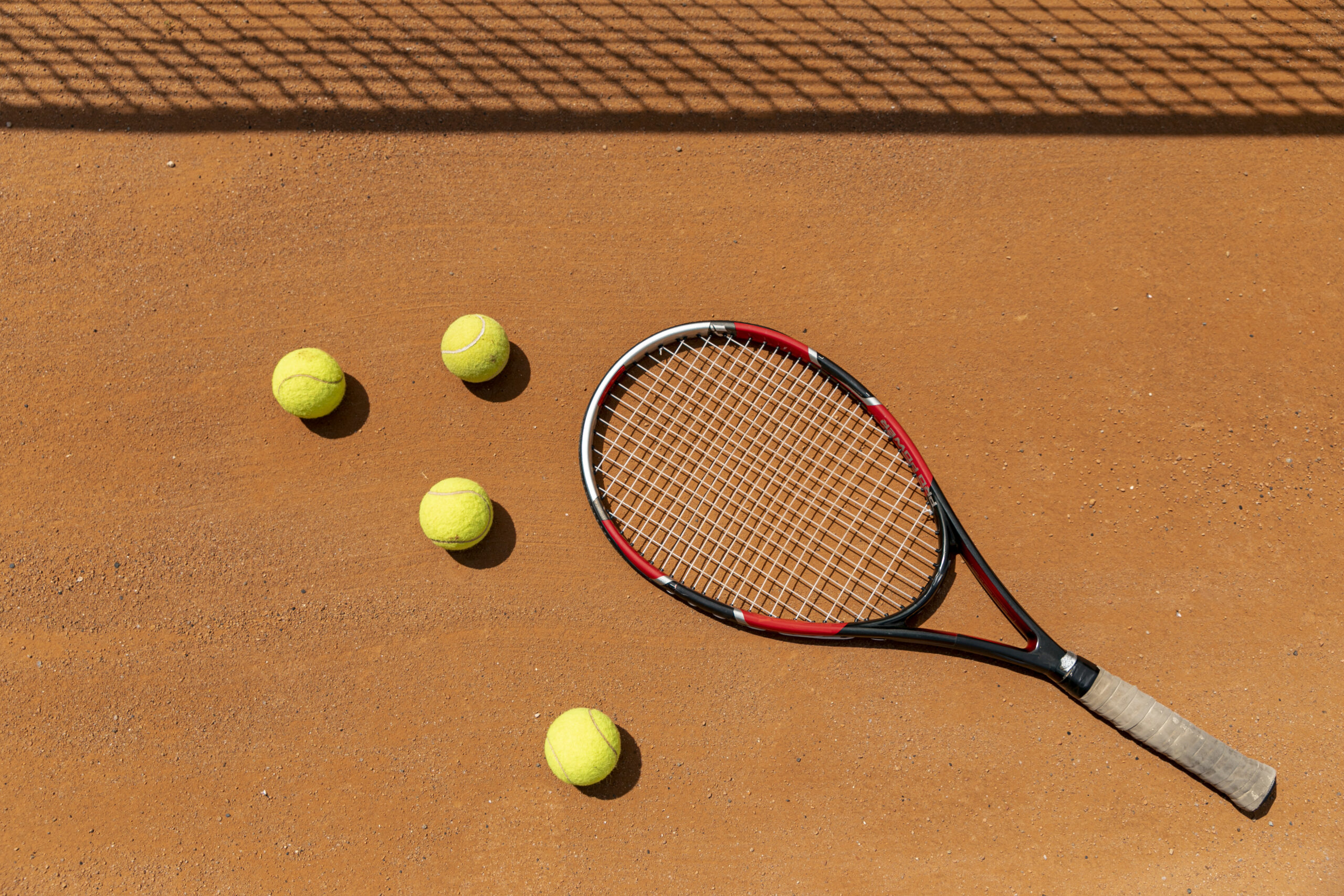 top-view-racket-tennis-balls-court-ground